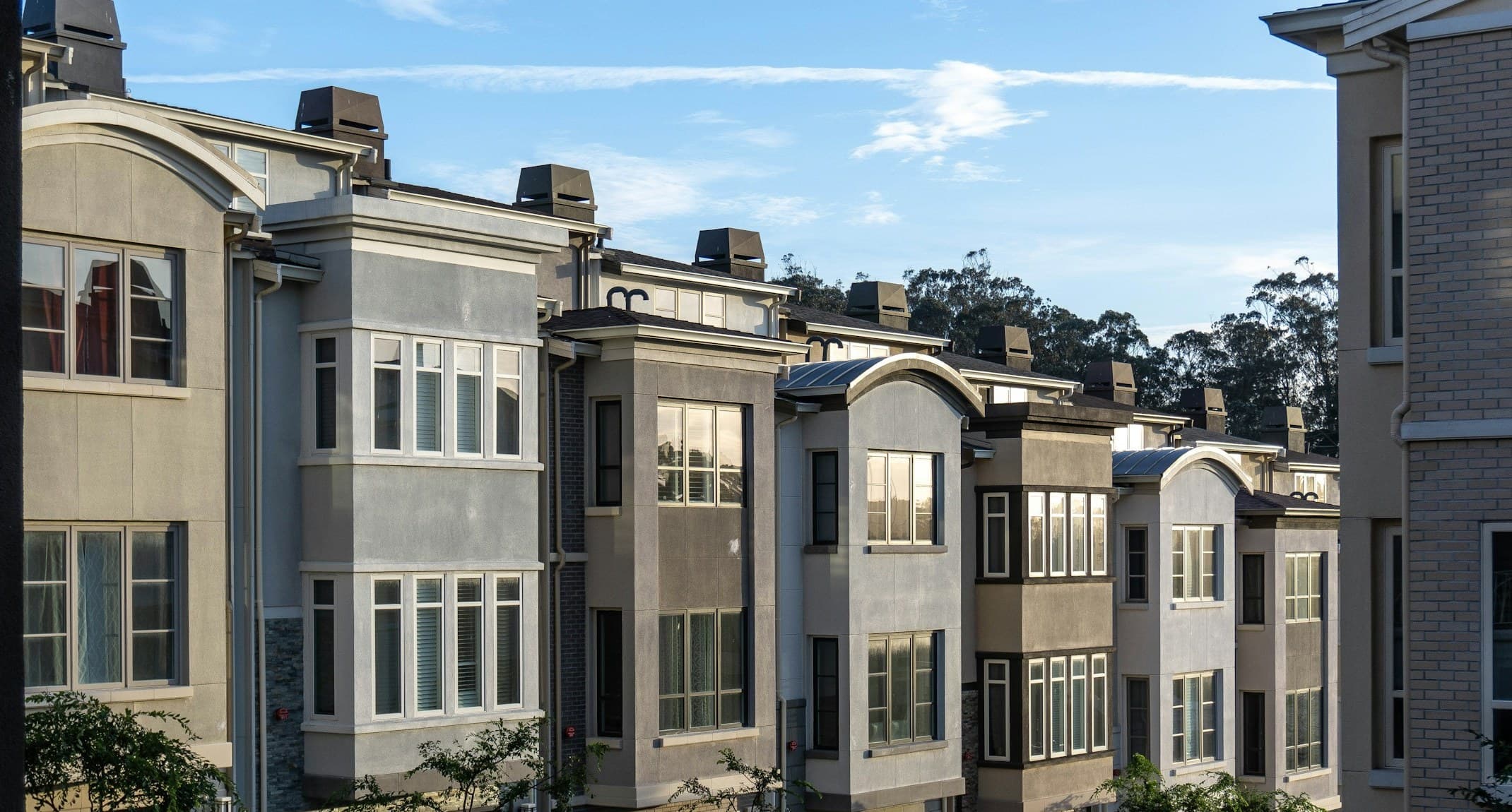 A row of modern multi-unit townhomes